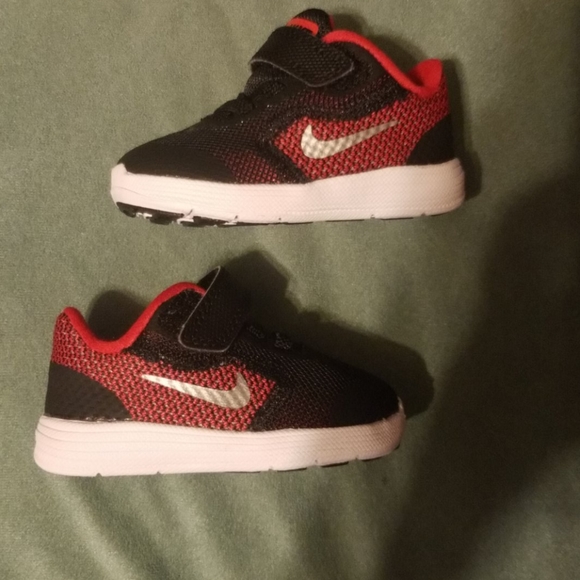 Red and black with metallic silver Nike shoes